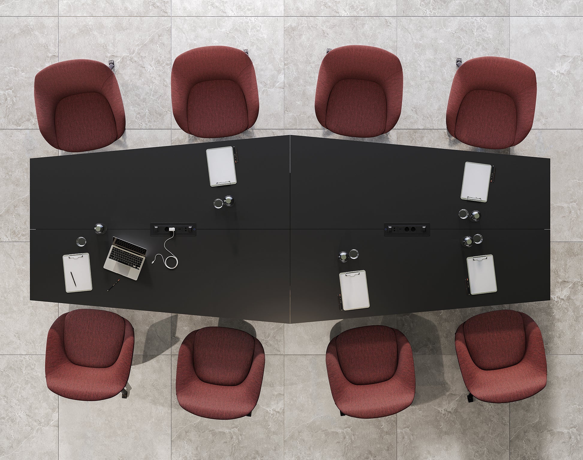 Vue aérienne de la table de réunion Mux70 de Stefano Boeri Interiors, entourée de huit chaises rouges. La table noire présente des ordinateurs portables, des tablettes, des cahiers, des verres d'eau et des câbles de recharge sur un sol carrelé gris.