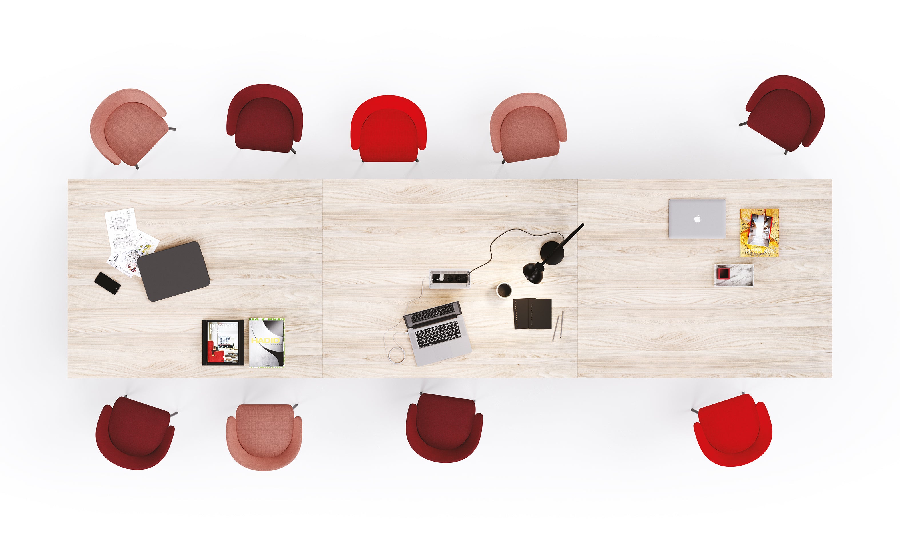 Vue aérienne du bureau Attitudes Table de réunion Pop Easy avec connectique intégrée, entourée de dix chaises rouges. Des ordinateurs portables, des documents, un magazine, des fournitures de bureau et une lampe sont posés sur la table dans cette salle de réunion informelle avec beaucoup d'espace blanc.