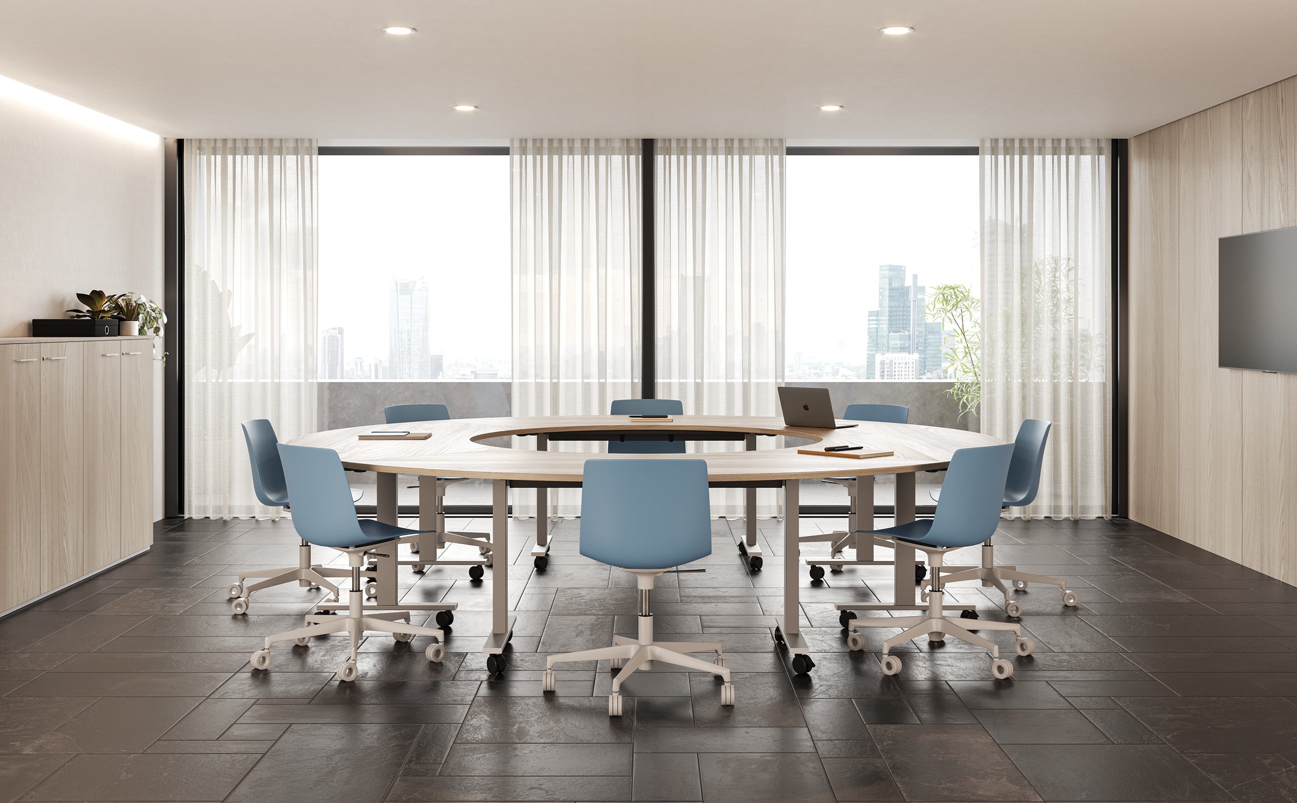 Salle de conférence moderne équipée de la Table de réunion pliante sur roulettes Pop Folding d'Attitudes Bureaux disposée en U, de six chaises bleues à roulettes, d'un ordinateur portable, de fenêtres allant du sol au plafond avec des rideaux transparents et d'une vue sur l'horizon de la ville.