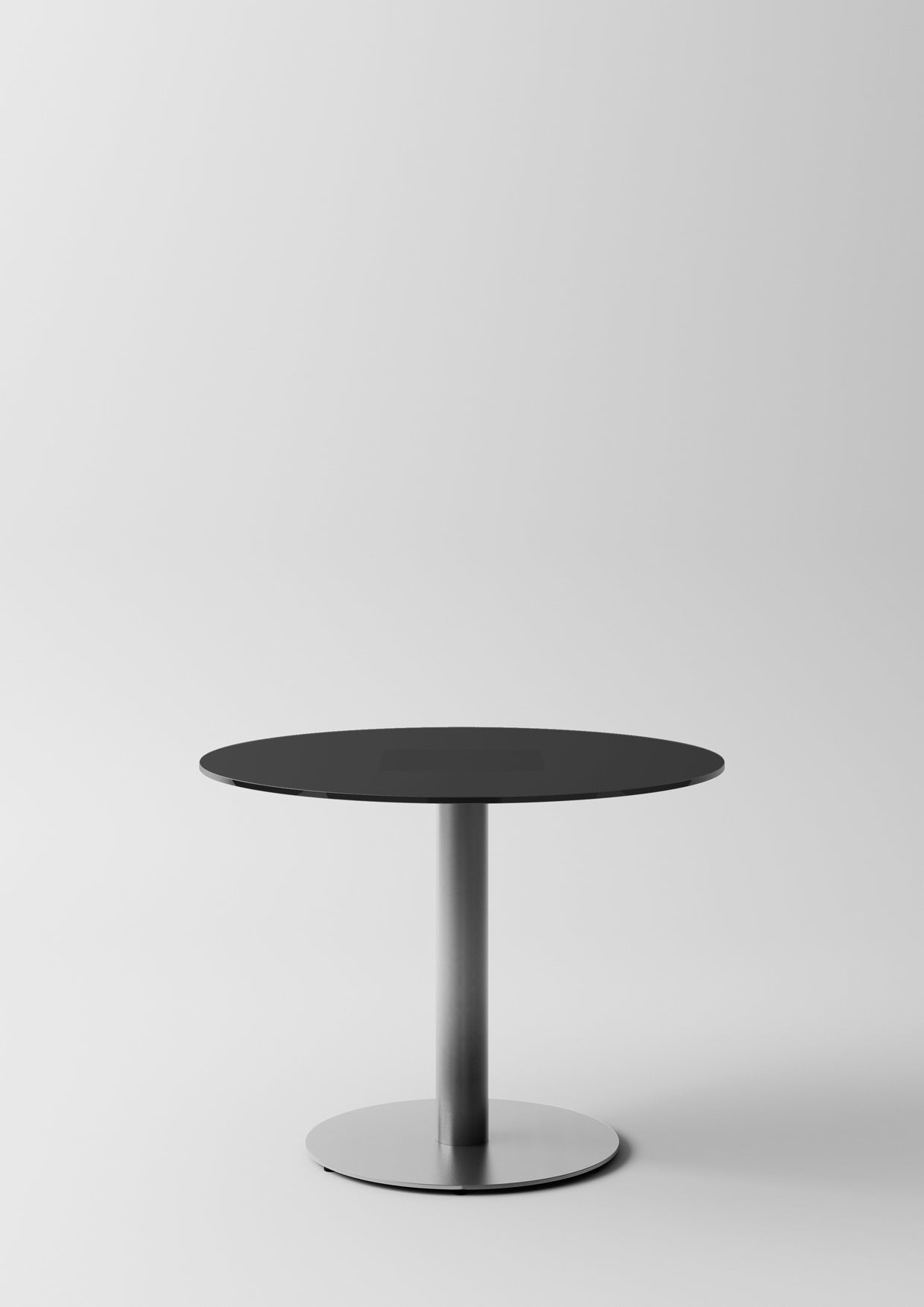 La Pop Tables de réunion et lounge d'Attitudes Bureaux est une table ronde moderne de couleur noire avec un socle unique en métal, idéale pour l'aménagement des bureaux ou comme table lounge chic, présentée sur un fond blanc uni.