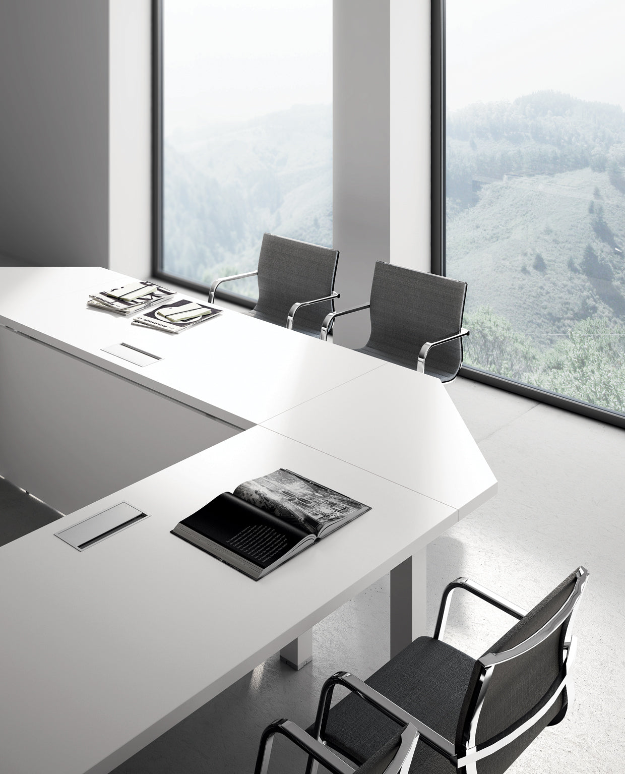 Une salle de conférence moderne et minimaliste avec deux chaises grises et des Attitudes Bureaux Tables de réunion Asset présentant des magazines et un livre ouvert. De grandes fenêtres donnent sur un paysage brumeux avec des collines et des arbres.