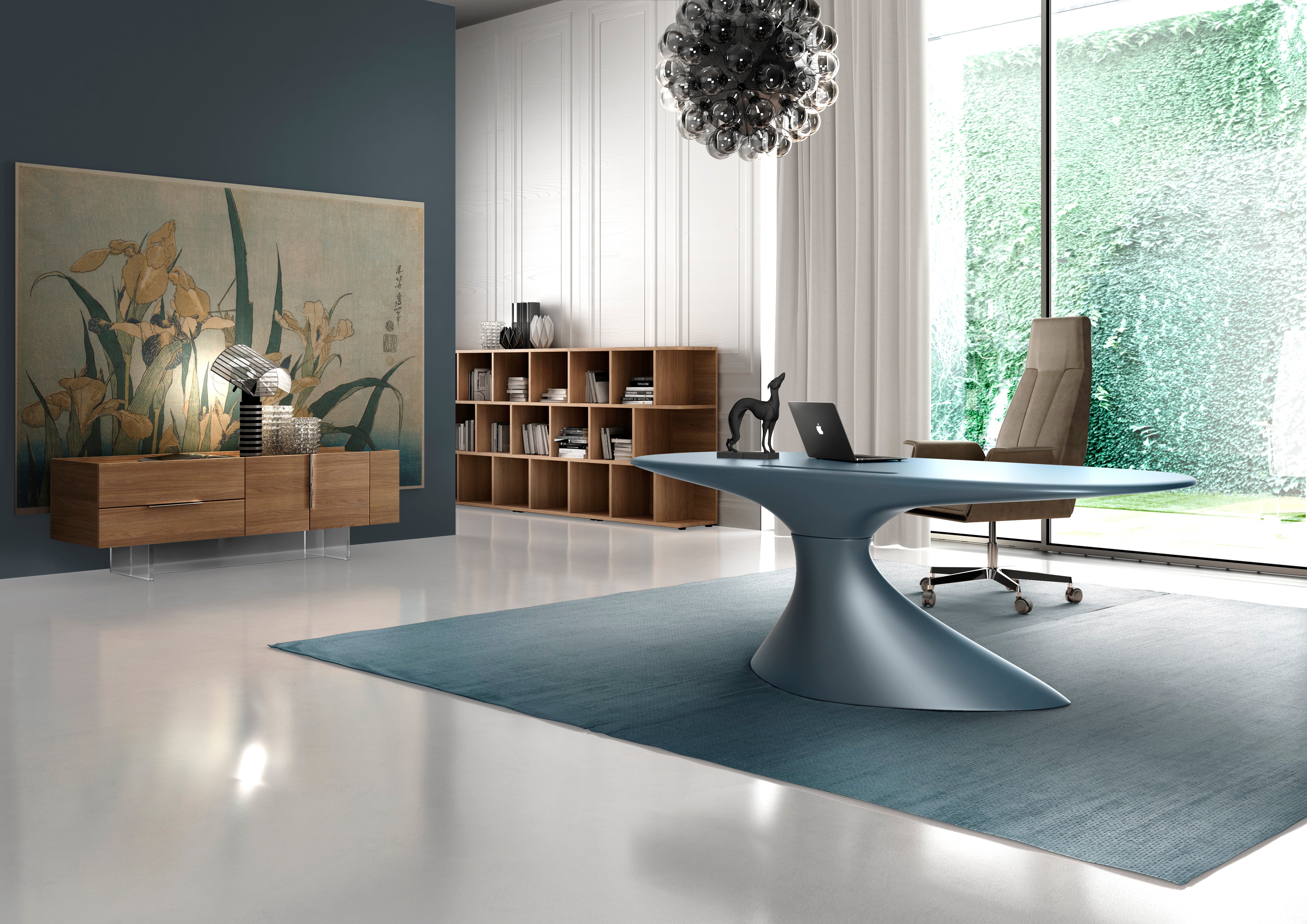 Ce bureau moderne comprend le bureau bleu sculptural ZERO de Karim Rashid, une chaise beige, un ordinateur portable, une figurine de chien noire et une étagère. De grandes œuvres d'art et une lampe métallique ornent le mur ; des fenêtres allant du sol au plafond mettent en valeur une végétation luxuriante.